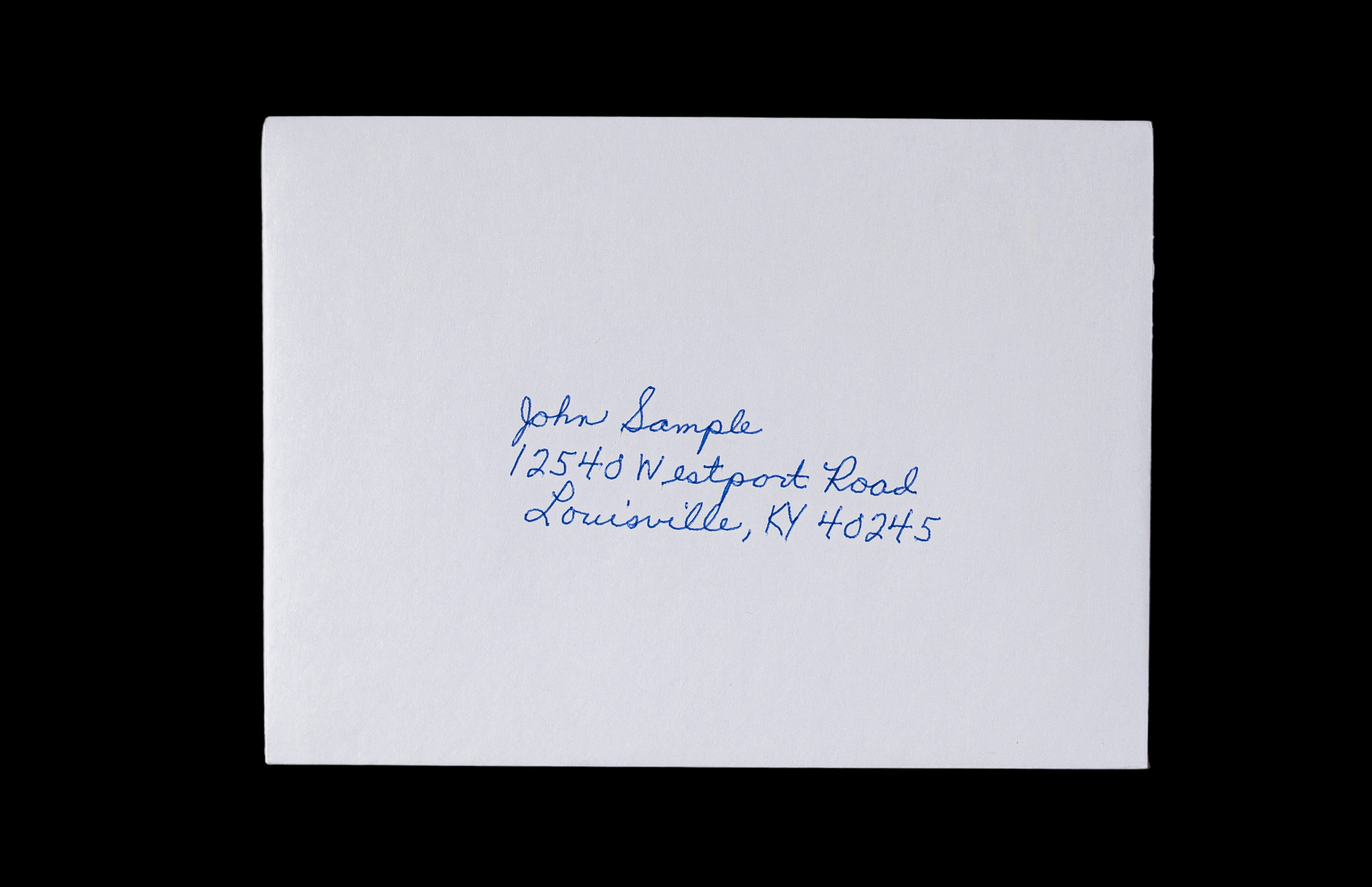 White envelope addressed by hand in blue ink